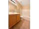 Clean bathroom with a tub, shower, and wood vanity at 8465 Bellery Ave, Las Vegas, NV 89143