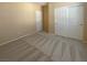 Well-lit bedroom featuring double door closet and carpet at 8465 Bellery Ave, Las Vegas, NV 89143