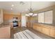 Kitchen with light wood cabinets, stainless steel appliances, and vinyl flooring at 8465 Bellery Ave, Las Vegas, NV 89143