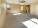 Spacious living room with neutral carpeting and ceiling fan at 8465 Bellery Ave, Las Vegas, NV 89143