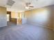 Spacious loft area with neutral carpet and ceiling fan at 8465 Bellery Ave, Las Vegas, NV 89143