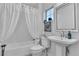 Clean bathroom with white vanity, tub, and shower at 9037 Grayling Dr, Las Vegas, NV 89134