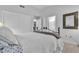 Cozy bedroom featuring a wrought iron bed, tile floors, and natural lighting at 9037 Grayling Dr, Las Vegas, NV 89134