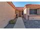 Front door with security screen and desert landscaping at 9037 Grayling Dr, Las Vegas, NV 89134