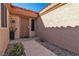 Front door with a security screen, desert landscaping and a red tile roof at 9037 Grayling Dr, Las Vegas, NV 89134