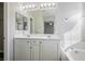 Main bathroom with double sinks, large mirror, and white cabinetry at 9328 Black Wolf Ave, Las Vegas, NV 89178