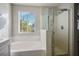 Bathroom featuring a shower, bathtub, and a window with mountain views at 9328 Black Wolf Ave, Las Vegas, NV 89178