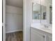 Bathroom with double vanity, walk-in closet, and mirrored medicine cabinets at 9328 Black Wolf Ave, Las Vegas, NV 89178