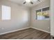 Spacious bedroom with hardwood floors and two windows at 9328 Black Wolf Ave, Las Vegas, NV 89178