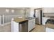 Kitchen island with granite countertop and stainless steel dishwasher at 9328 Black Wolf Ave, Las Vegas, NV 89178