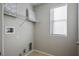 Bright laundry room with window and built-in shelving at 9328 Black Wolf Ave, Las Vegas, NV 89178