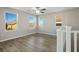 Spacious loft bedroom with wood flooring and large windows at 9328 Black Wolf Ave, Las Vegas, NV 89178