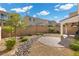 Landscaped backyard with a circular patio and rock features at 9625 Ponderosa Skye Ct, Las Vegas, NV 89166