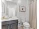 Bathroom featuring a dark vanity, a neutral shower curtain, and natural lighting at 9625 Ponderosa Skye Ct, Las Vegas, NV 89166