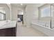 Bathroom with soaking tub, double sink vanity, neutral paint colors and tile flooring at 9625 Ponderosa Skye Ct, Las Vegas, NV 89166