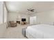 Bedroom with a seating area, large windows, neutral paint colors, carpet and a ceiling fan at 9625 Ponderosa Skye Ct, Las Vegas, NV 89166