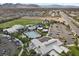 Aerial view of a resort-style community pool area with a pool, splash pad, and clubhouse at 9625 Ponderosa Skye Ct, Las Vegas, NV 89166