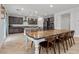 Open concept dining area with farmhouse table and chairs near kitchen at 9625 Ponderosa Skye Ct, Las Vegas, NV 89166