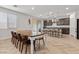 Bright dining area with white table and wooden chairs, adjacent to kitchen at 9625 Ponderosa Skye Ct, Las Vegas, NV 89166