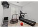 A home gym with a treadmill, stationary bike, and natural light at 9625 Ponderosa Skye Ct, Las Vegas, NV 89166