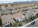 Aerial view of a two-story home with a brick driveway, a two-car garage, and mature landscaping at 9625 Ponderosa Skye Ct, Las Vegas, NV 89166