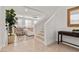 Open foyer with a staircase, plant in the corner, light colored walls, and tile flooring at 9625 Ponderosa Skye Ct, Las Vegas, NV 89166