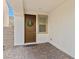 Front entry with brown door, wreath, and brick flooring at 9625 Ponderosa Skye Ct, Las Vegas, NV 89166