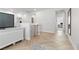 Hallway with herringbone floors and a white entertainment center with a view of the office at 9625 Ponderosa Skye Ct, Las Vegas, NV 89166