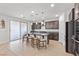 An open kitchen island with stone countertops, pendant lighting, and seating at 9625 Ponderosa Skye Ct, Las Vegas, NV 89166