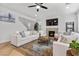 Bright living room features a ceiling fan, fireplace, and comfortable seating around a wooden coffee table at 9625 Ponderosa Skye Ct, Las Vegas, NV 89166