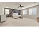 Large, brightly lit main bedroom features a floral accent wall and plush neutral carpeting at 9625 Ponderosa Skye Ct, Las Vegas, NV 89166