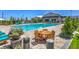 Beautiful community pool area featuring lounge seating, tables, and well-maintained landscaping at 9625 Ponderosa Skye Ct, Las Vegas, NV 89166