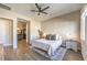 Bright bedroom with ceiling fan, wood floors, and ensuite bathroom at 10220 Tree Blossom Ave, Las Vegas, NV 89166