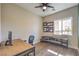 Home office with wood desk, chair, and window at 10220 Tree Blossom Ave, Las Vegas, NV 89166