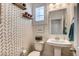 Stylish powder room with pedestal sink and unique patterned wallpaper at 10456 Skye Knoll Ave, Las Vegas, NV 89166