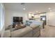 Open living area with gray couch and kitchen island at 10774 Blore Ct, Las Vegas, NV 89166