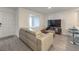 Spacious living room with gray sectional sofa and modern TV stand at 10774 Blore Ct, Las Vegas, NV 89166