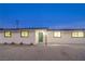 Updated single story home with a green door and small front yard at 1302 Cherokee Ln, Las Vegas, NV 89106