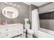 Modern bathroom with gray tile, white vanity, and bathtub at 1308 Royal Creek Ct, North Las Vegas, NV 89031