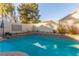 Tranquil swimming pool surrounded by lush landscaping and a private backyard setting at 1308 Royal Creek Ct, North Las Vegas, NV 89031