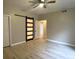 Bedroom features hardwood floors, ceiling fan, closet and door leading to other rooms at 1409 E St Louis Ave # A, Las Vegas, NV 89104