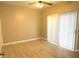Bright bedroom featuring wood-look flooring, vertical blinds, a ceiling fan, and neutral paint at 1409 E St Louis Ave # A, Las Vegas, NV 89104