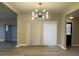 Dining area with wood floors, vertical blinds, and a modern chandelier at 1409 E St Louis Ave # A, Las Vegas, NV 89104