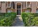 Exterior view of building with stone steps leading to the black gate and trimmed shrubs at 1409 E St Louis Ave # A, Las Vegas, NV 89104