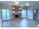 Bright living room featuring a marble fireplace, two light fixtures, and sliding door access at 1409 E St Louis Ave # A, Las Vegas, NV 89104