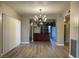 Living room featuring wood floors, a modern chandelier, and access to the kitchen and patio at 1409 E St Louis Ave # A, Las Vegas, NV 89104