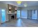 Bright living room featuring a marble fireplace, two light fixtures, and sliding door access at 1409 E St Louis Ave # A, Las Vegas, NV 89104