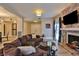Open living room with sectional sofa, fireplace and hardwood floors at 1409 E St Louis Ave # A, Las Vegas, NV 89104