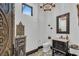 Elegant powder room with ornate mirror, custom vanity, and patterned tile floor at 1616 Villa Rica Dr, Henderson, NV 89052