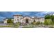 Elegant stucco home boasts a tiled roof, arched entryway, manicured landscaping, and lush greenery at 1616 Villa Rica Dr, Henderson, NV 89052